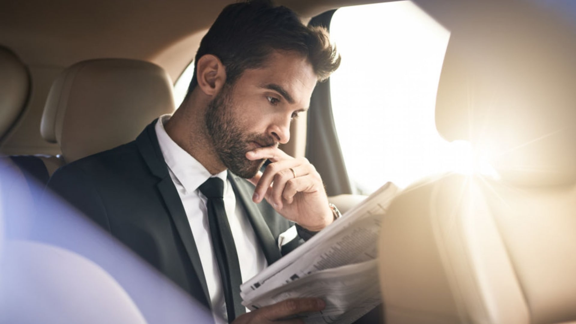 reading-news-in-car