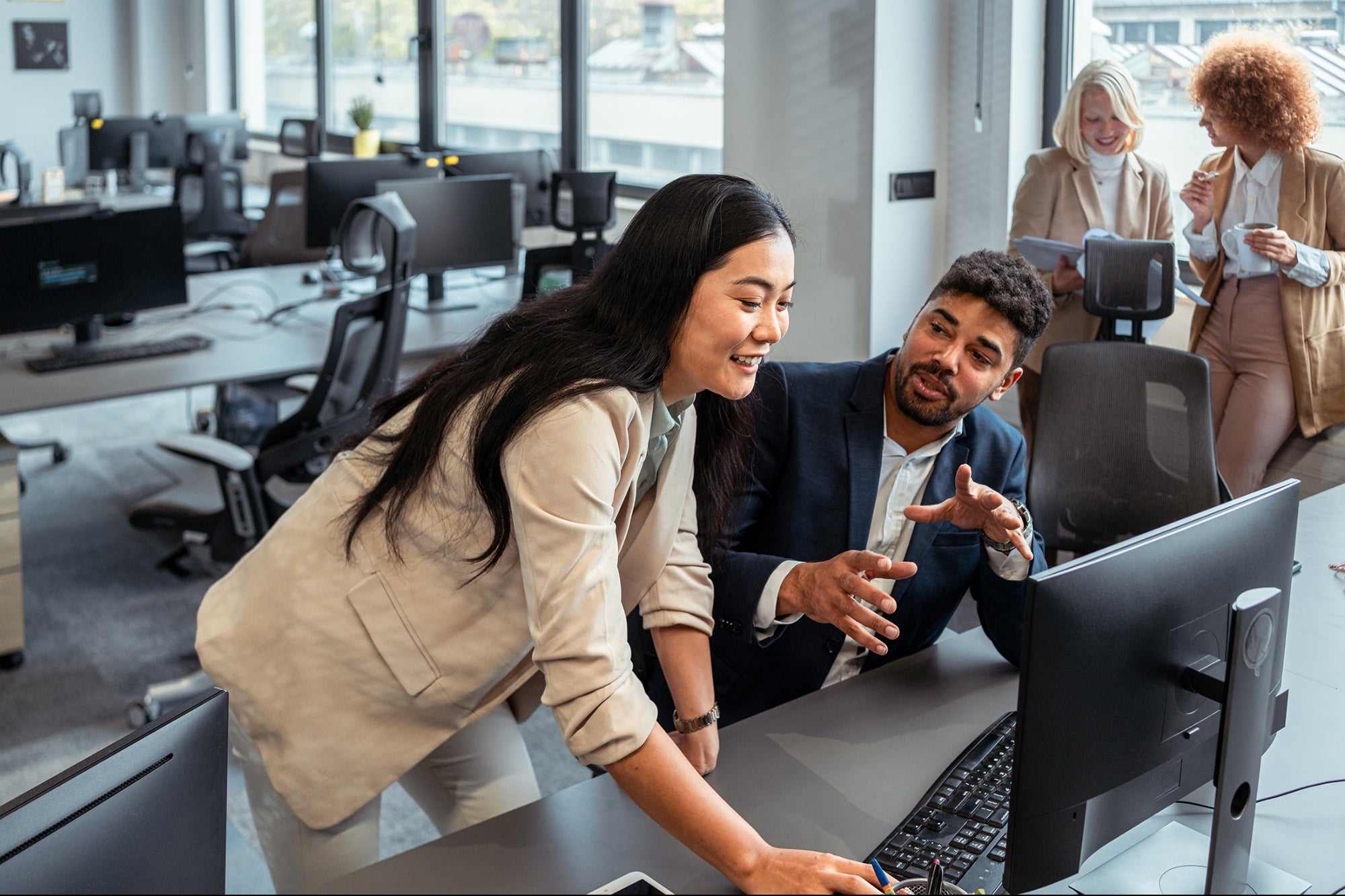 women-smiling-working-at-computer