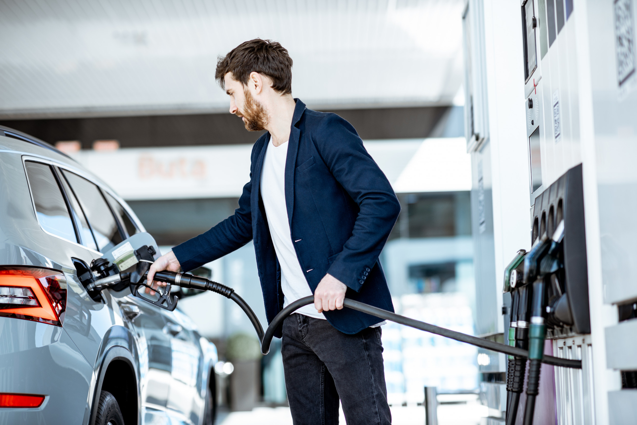 man-refueling-car